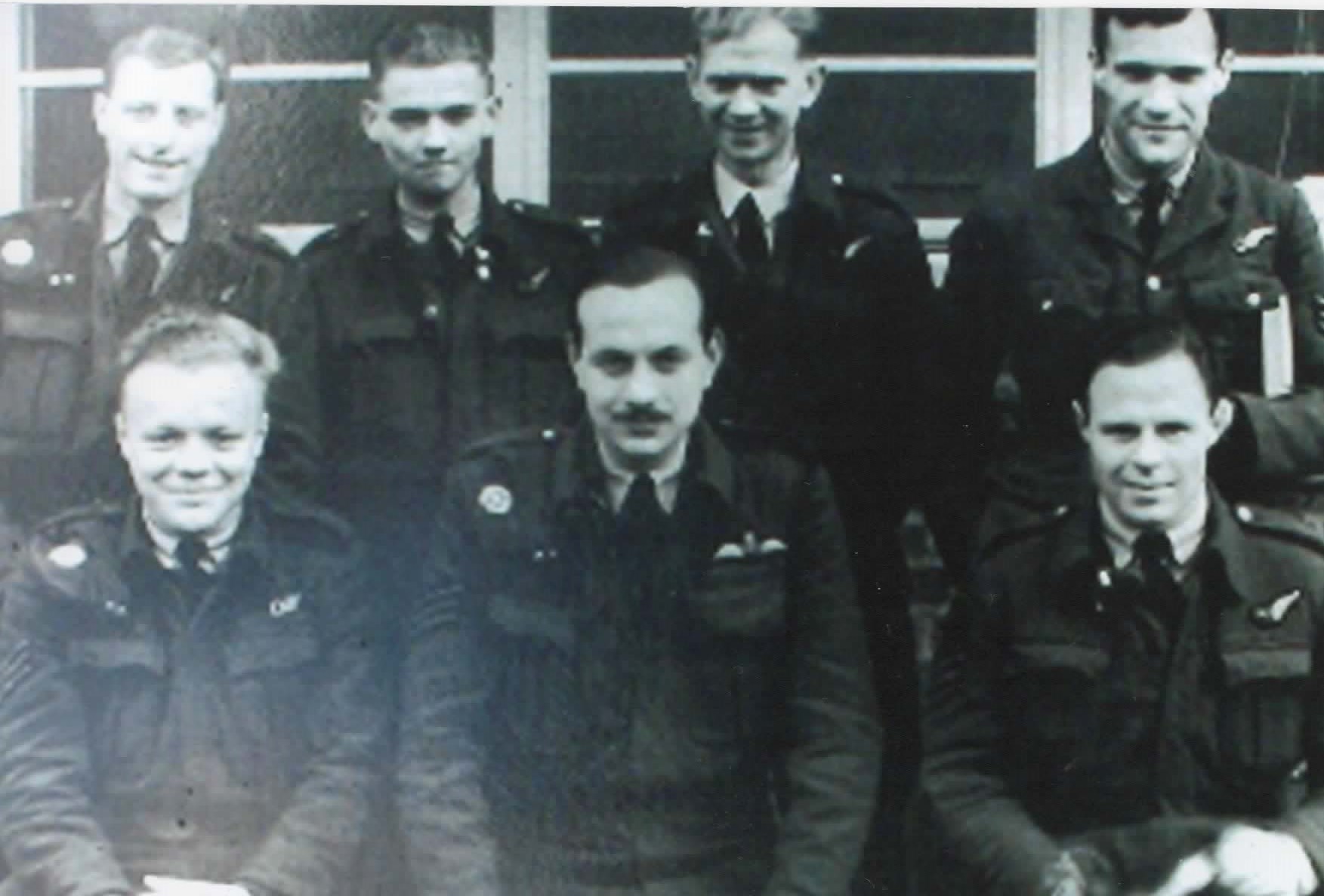 George (centre, holding book) with his Stirling crew, October 1942.