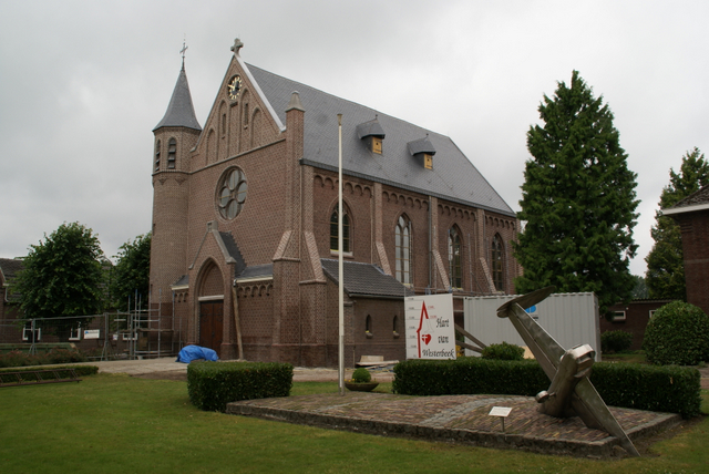 The Roman Catholic Church at Westerbeek, where William and his crew are buried. A scaled Lancaster tail-plane sculpture, made from metal of the downed aircraft, lies on the village green outside.
